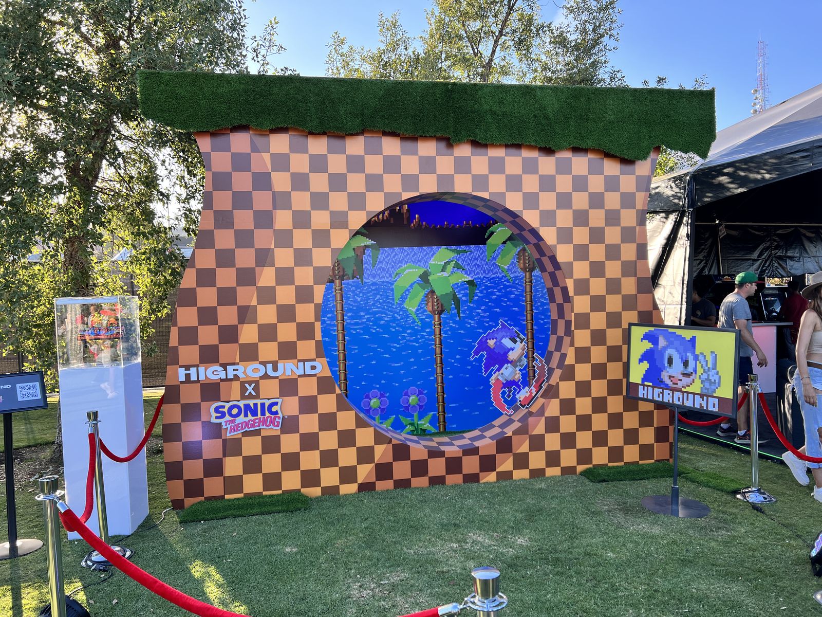 Checkered retro video game portal photo op on grass